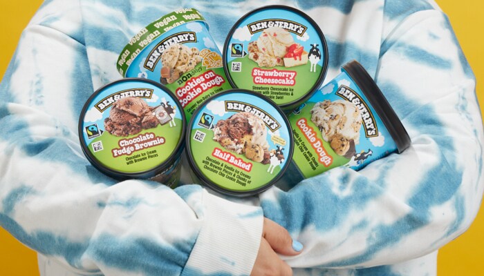 Persons arms filled with pints of Ben & Jerry's Ice Cream